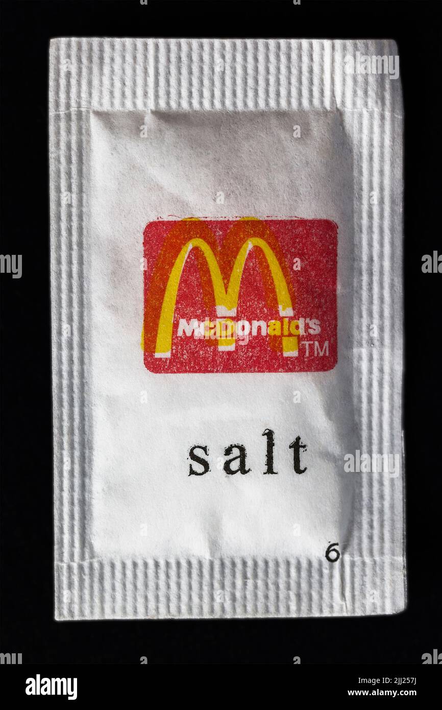 Salt sachet on black background from McDonald's restaurant Stock Photo