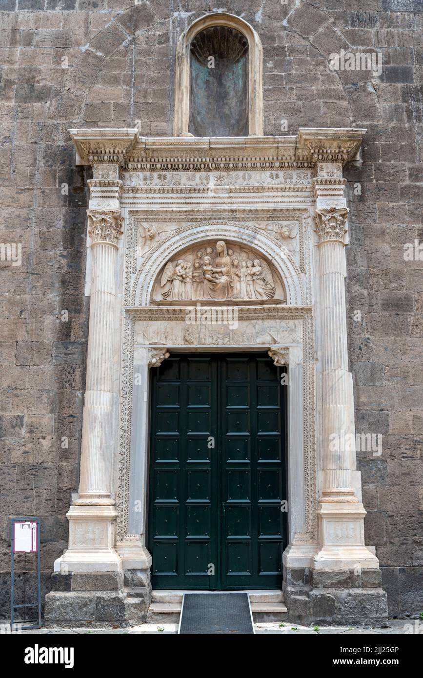 Door frame carved in marble decorating the entrance of medieval church in naples, Italy Stock Photo