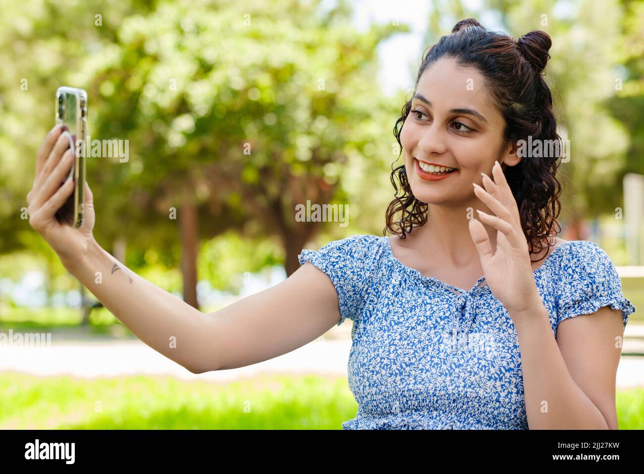 Young brunette girl smiling happy wearing summer dress on city park ...