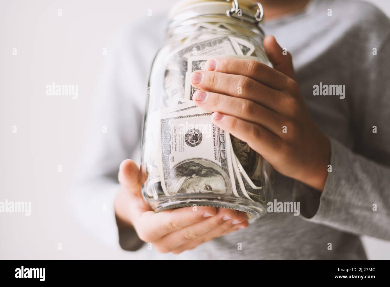 Kid save money. Put money in a piggy bank Stock Photo Alamy