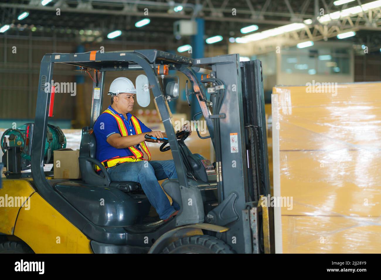 Forklift are loading into cargo containers at warehouses, ports, freight forwarding, cargo supply chains, cargo transportation, warehouse industry, lo Stock Photo