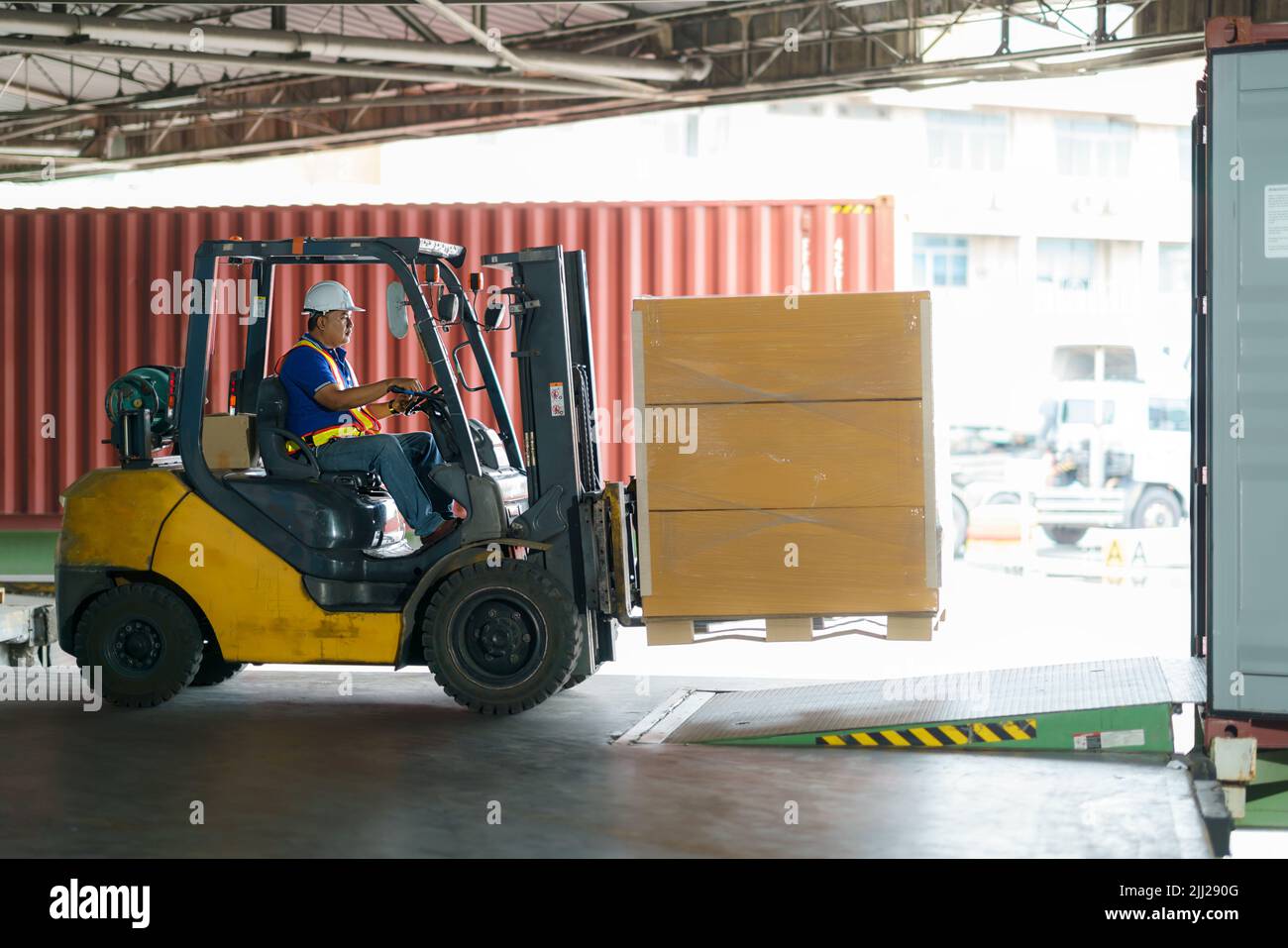 Forklift are loading into cargo containers at warehouses, ports, freight forwarding, cargo supply chains, cargo transportation, warehouse industry, lo Stock Photo