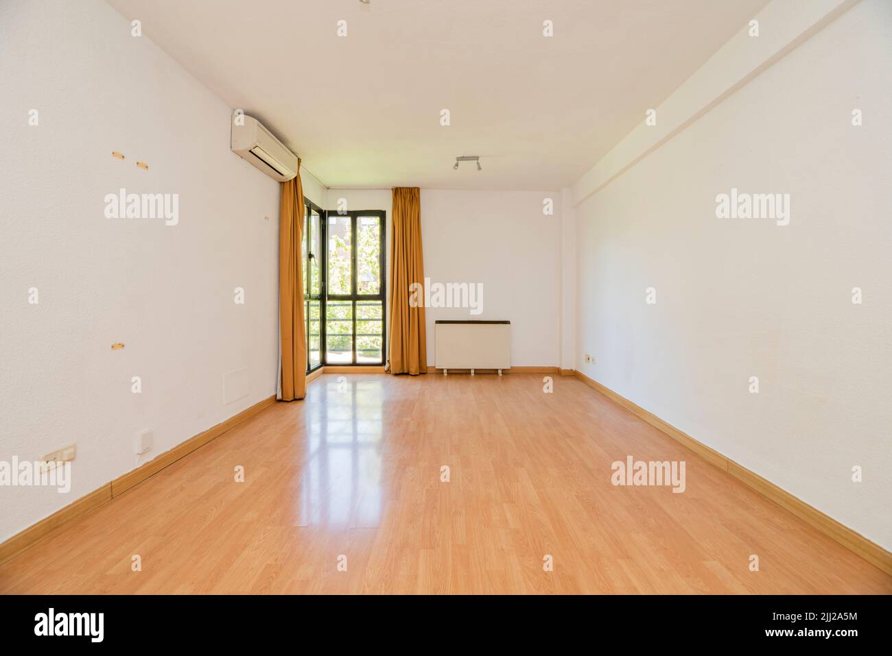 Living room with wooden floors, air conditioner and bay window in one