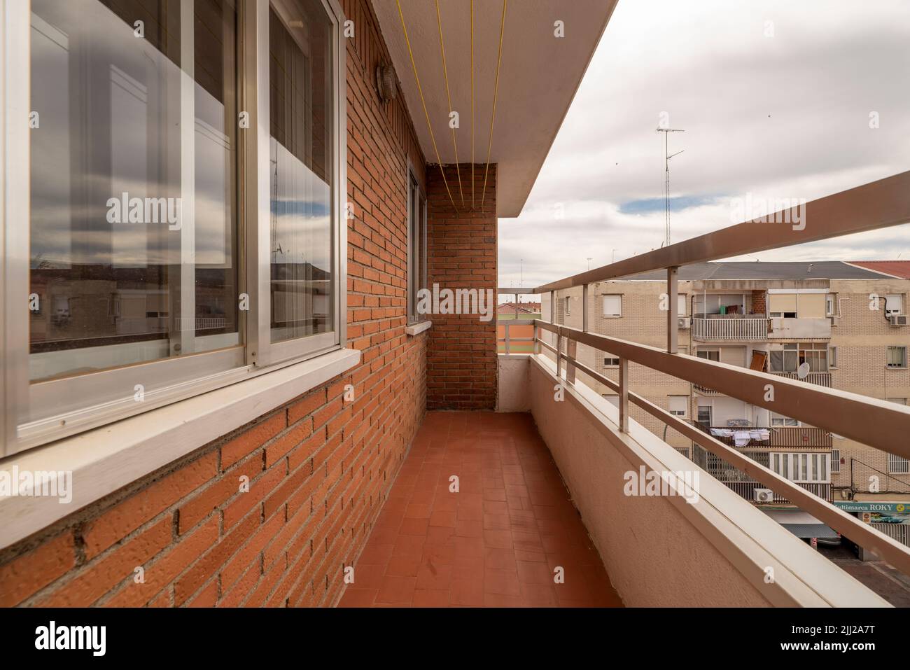 Terrace of an apartment with mud brick walls and views of the city ... - Terraced Apartments With City Views