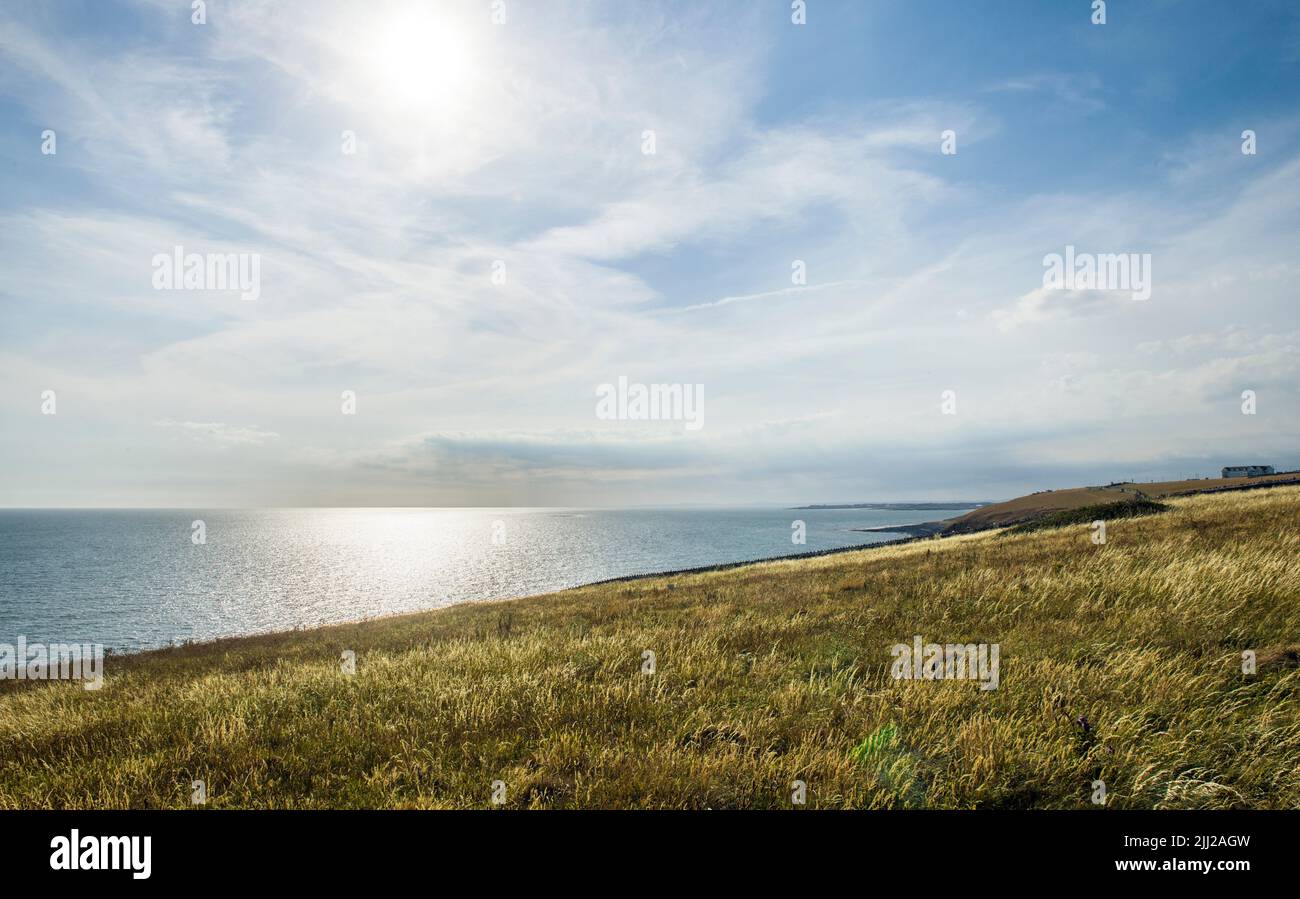 Looking out to sea from above Dunraven Bay on a lovely Summer Evening in the Vale of Glamorgan Stock Photo