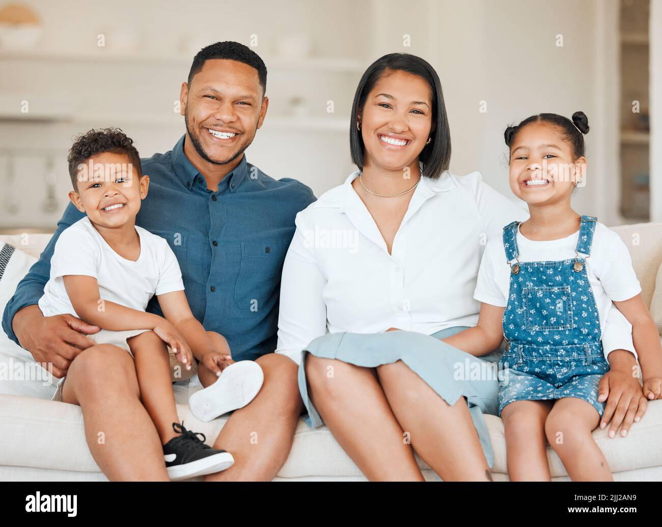 Family is forever. a young family happily bonding together on the sofa at home. Stock Photo