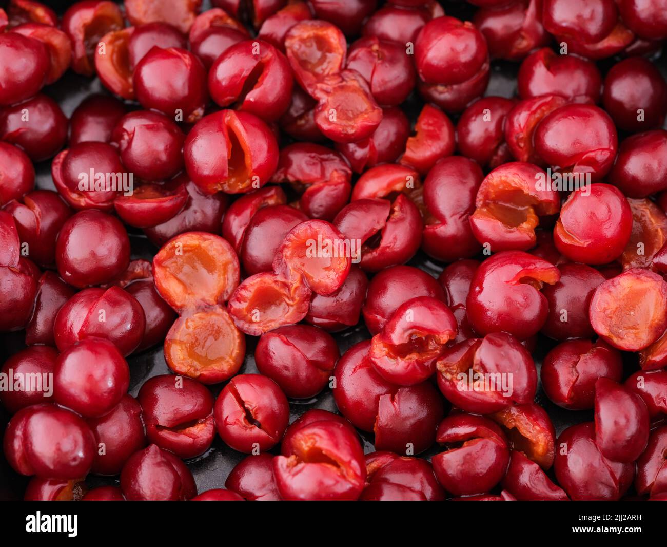 A lot of pitted cherries on a baking tray. Full frame Stock Photo