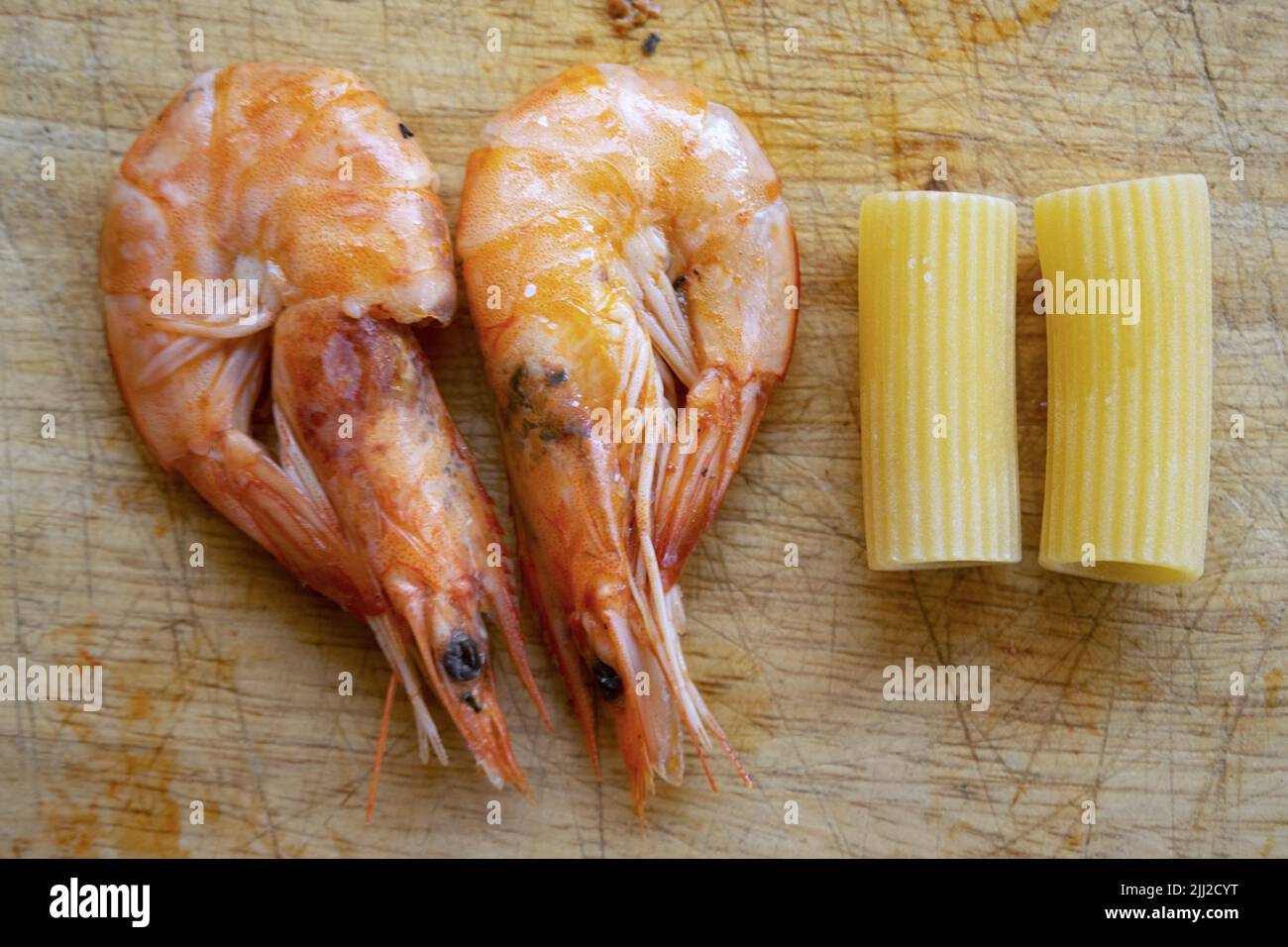pasta with prawns flat lay of two prawns and two rigatoni Stock Photo