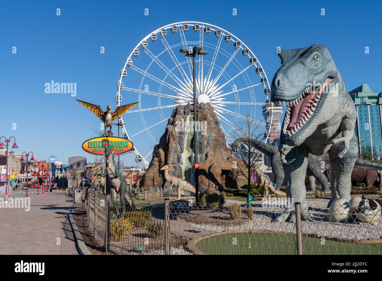 Downtown Niagara Falls City Clifton Hill amusement area. Dinosaur Adventure Golf. Skywheel ferris wheel. Stock Photo