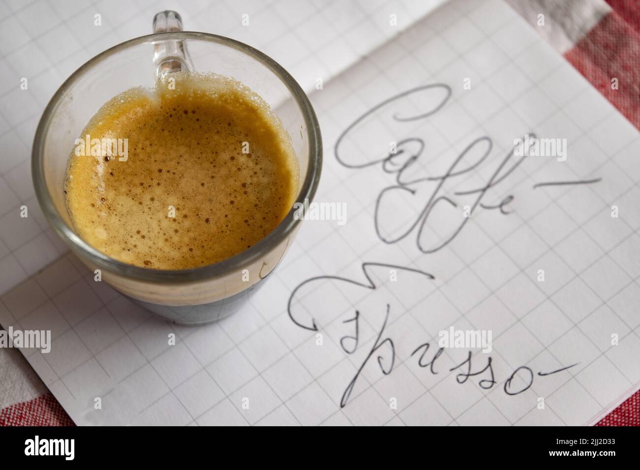 cup of espresso coffee on a book with the written caffè espresso Stock Photo