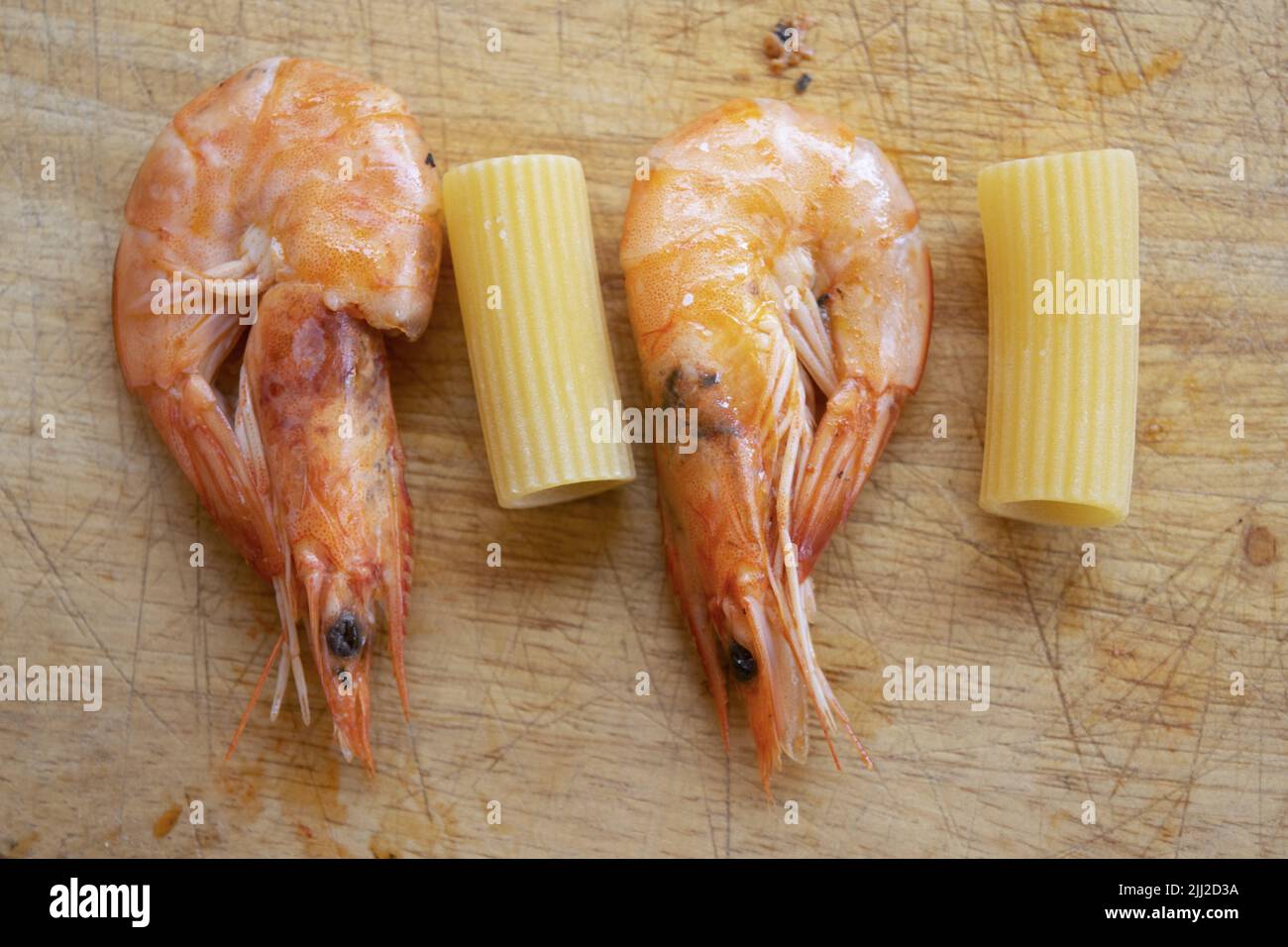 pasta with prawns flat lay of two prawns and two rigatoni Stock Photo
