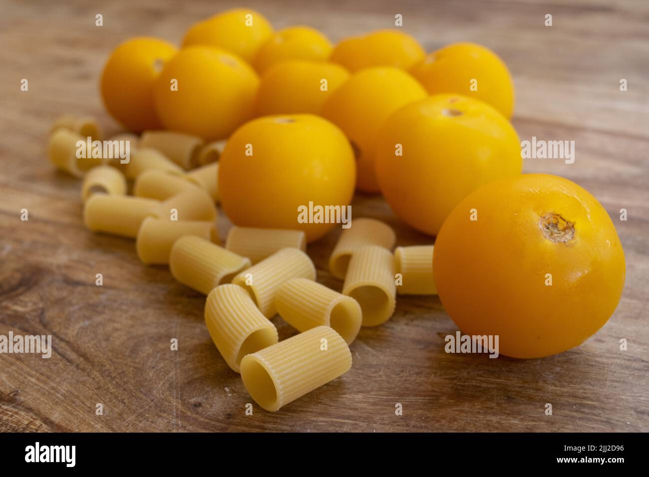 ingredients to prepare pasta with fresh yellow tomato sauce Stock Photo