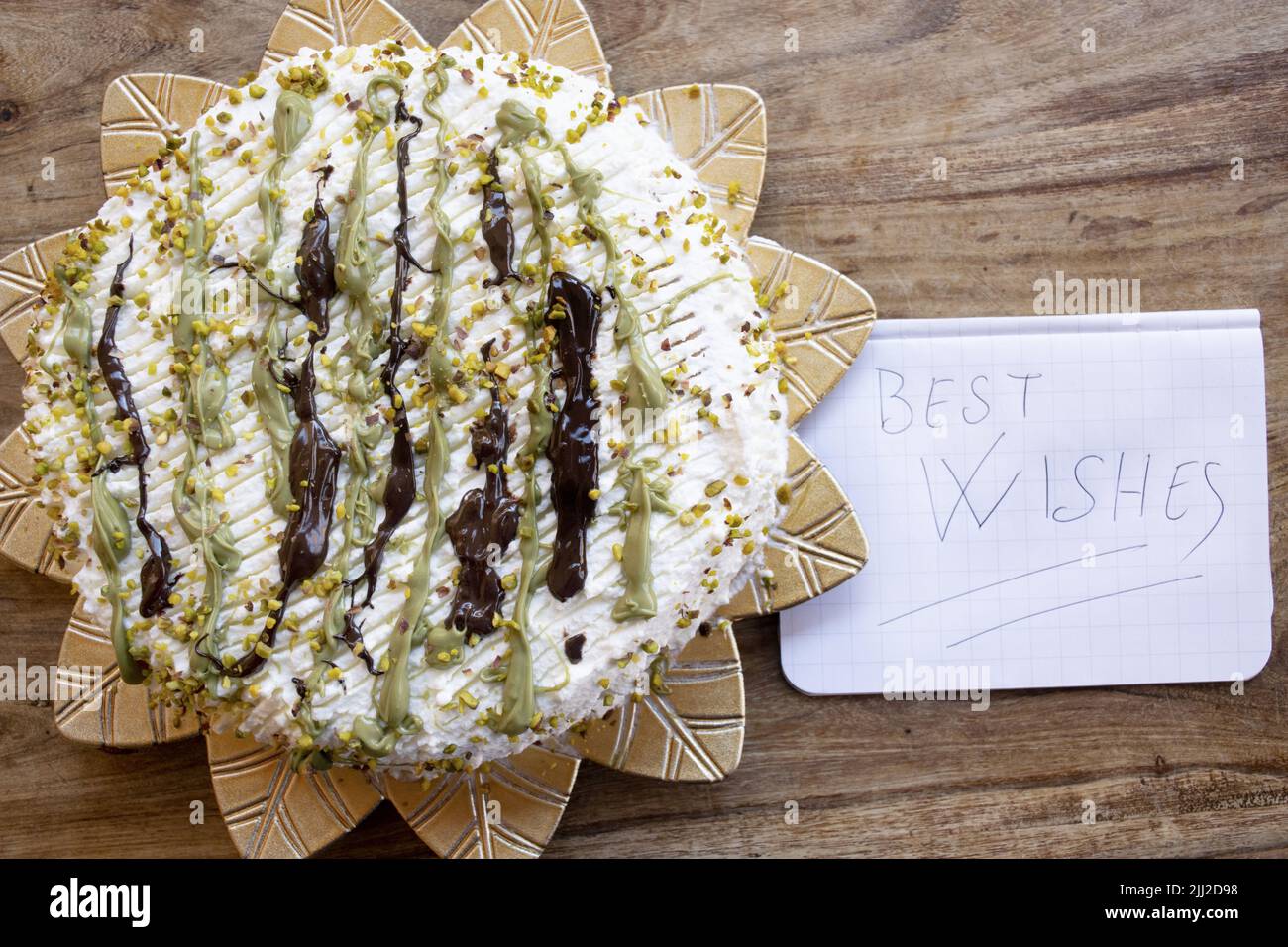 pistachio and chocolate cake with the inscription best wishes Stock Photo