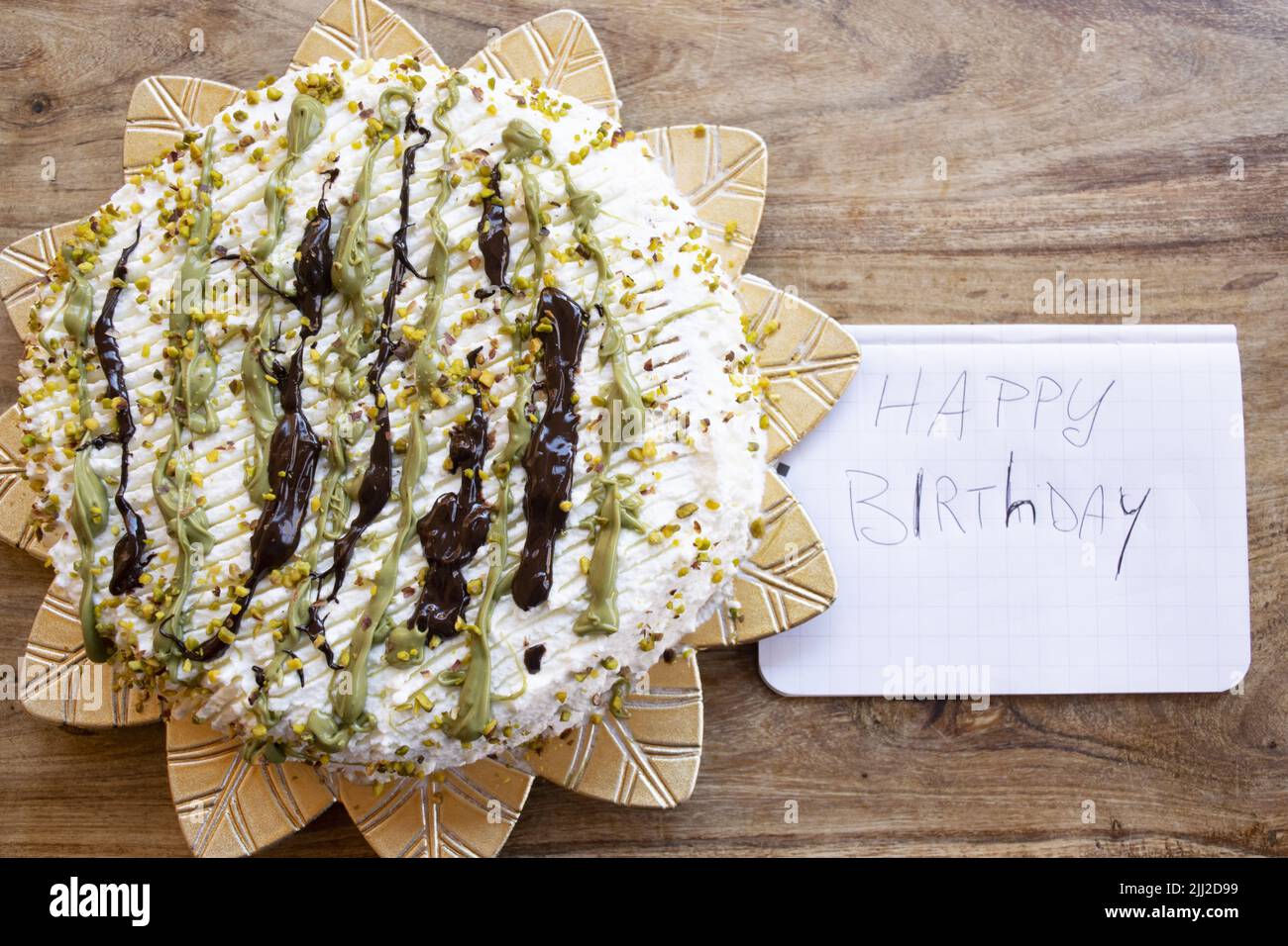 pistachio and chocolate cake with the inscription happy birthday Stock Photo