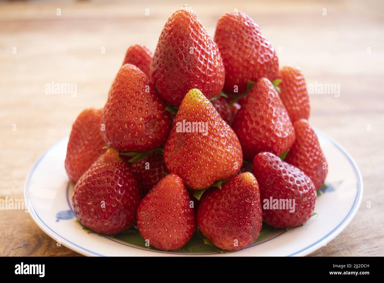 pile of fresh strawberries arranged in a pyramid Stock Photo