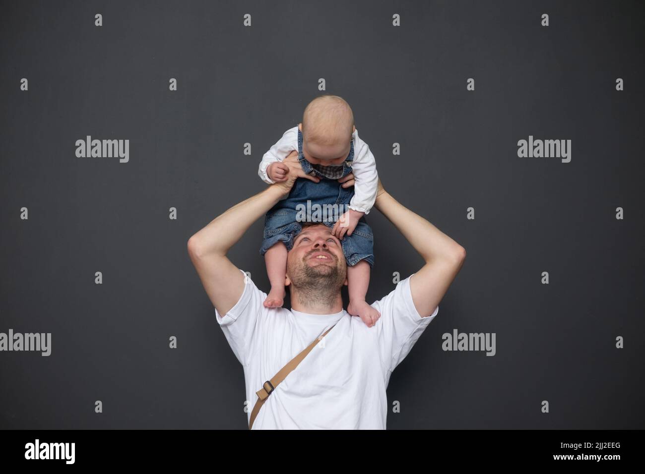 Outdoor portrait of young father hugging his little daughter Stock Photo