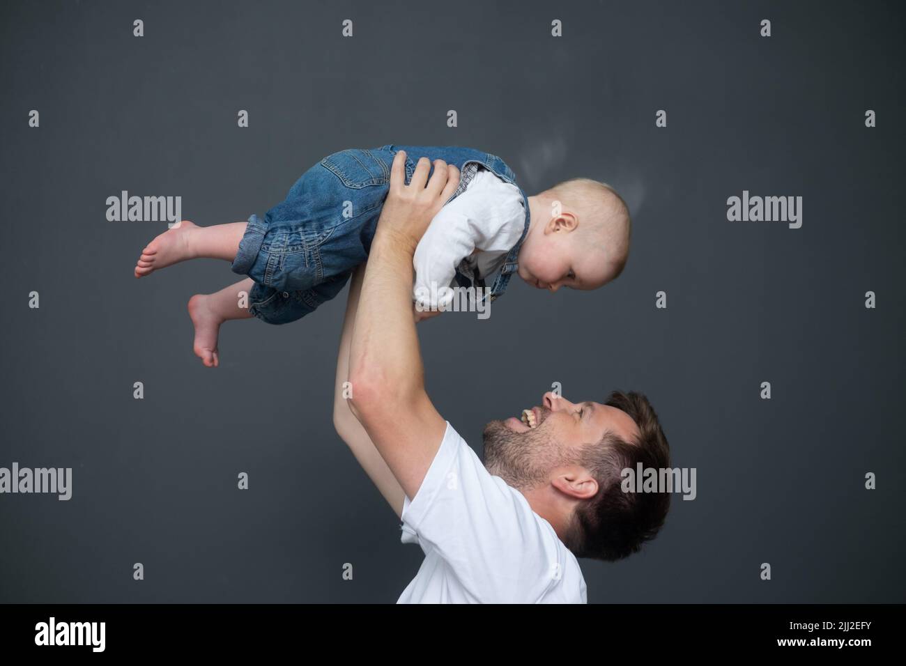 Outdoor portrait of young father hugging his little daughter Stock Photo