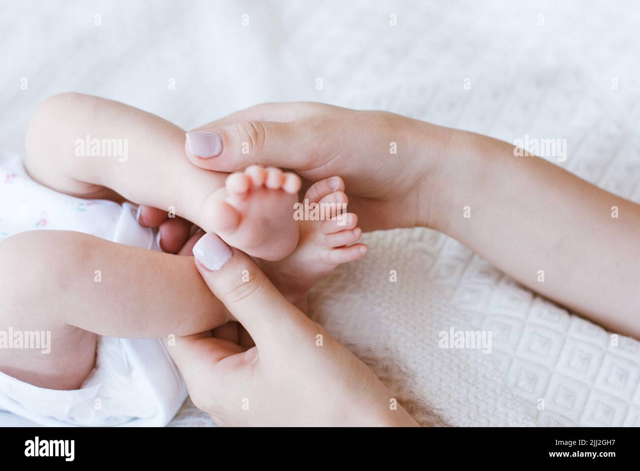 mother foot massage newborn baby Stock Photo Alamy