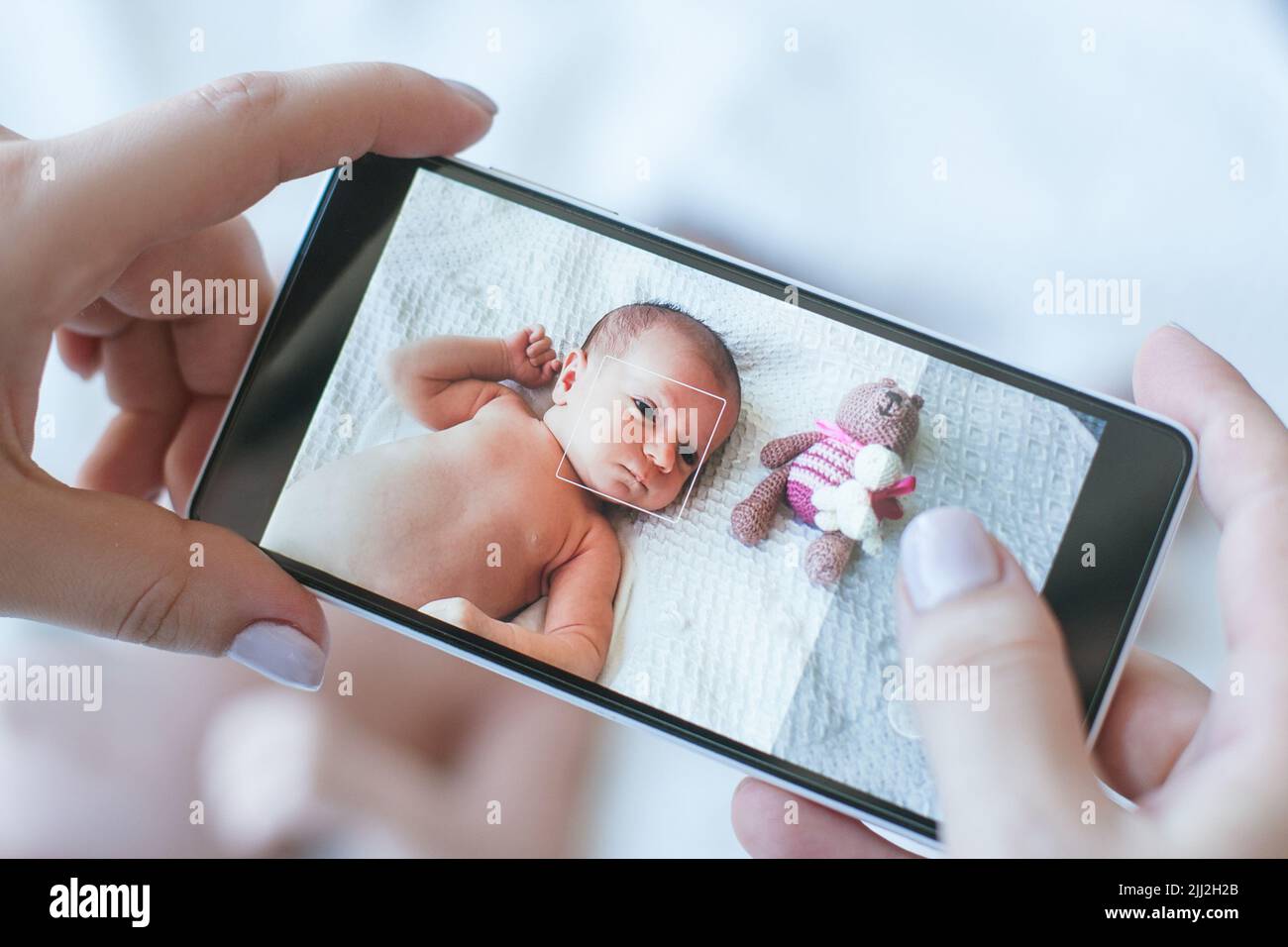 mother take a smartphone photo of her newborn baby Stock Photo