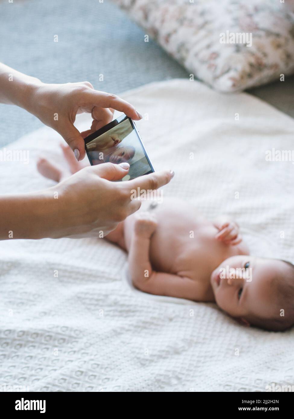 mother take a smartphone photo of her newborn baby Stock Photo