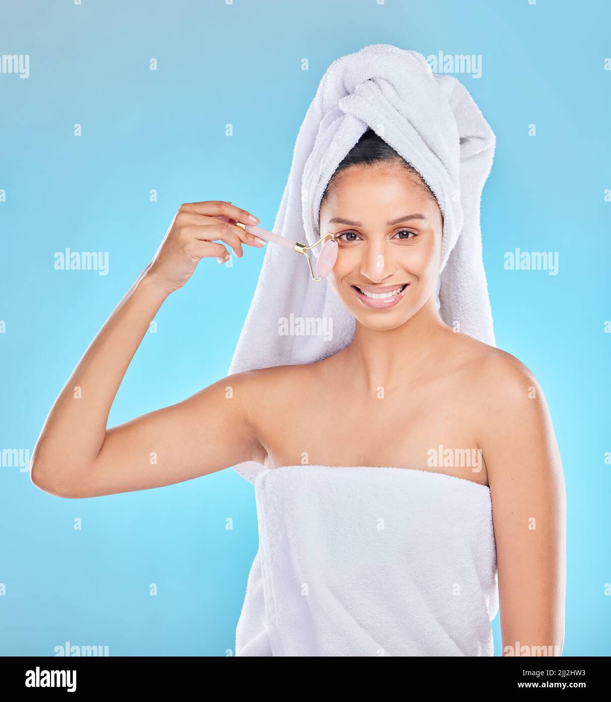 After shower treatment. Studio portrait of an attractive young woman applyng antiaging serum to