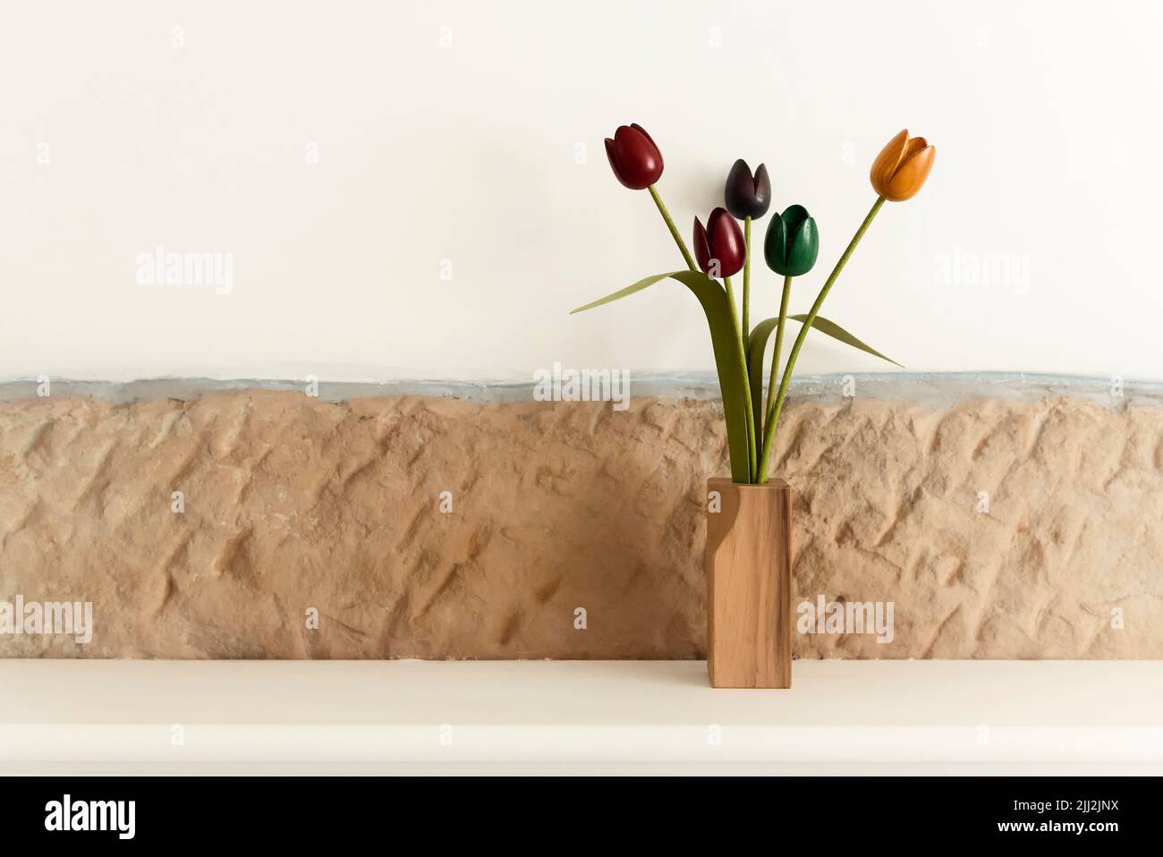 Wooden tulips on mantelpiece Stock Photo