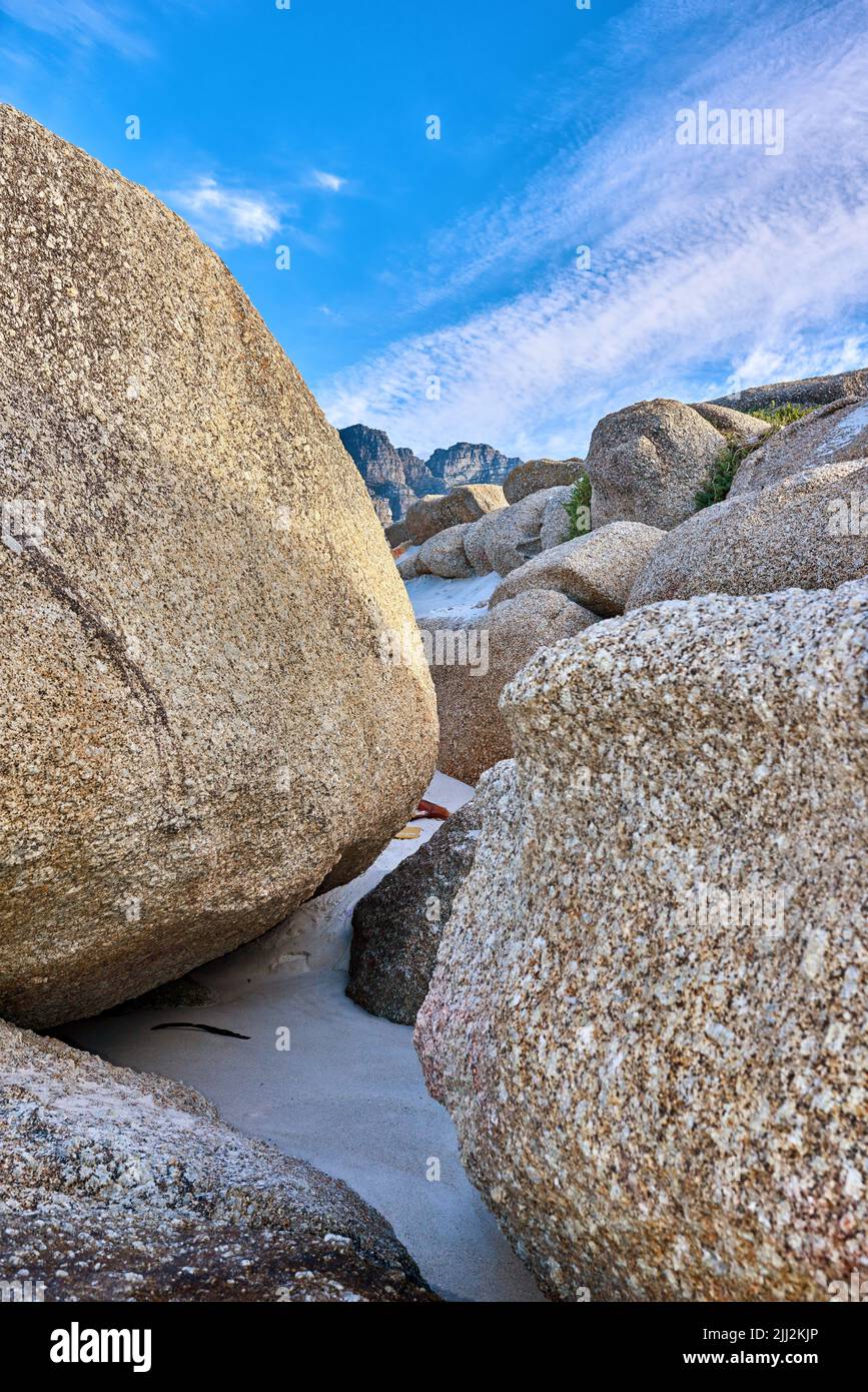 Rocky coast. Big rocks on the beach with a blue sky background on a ...