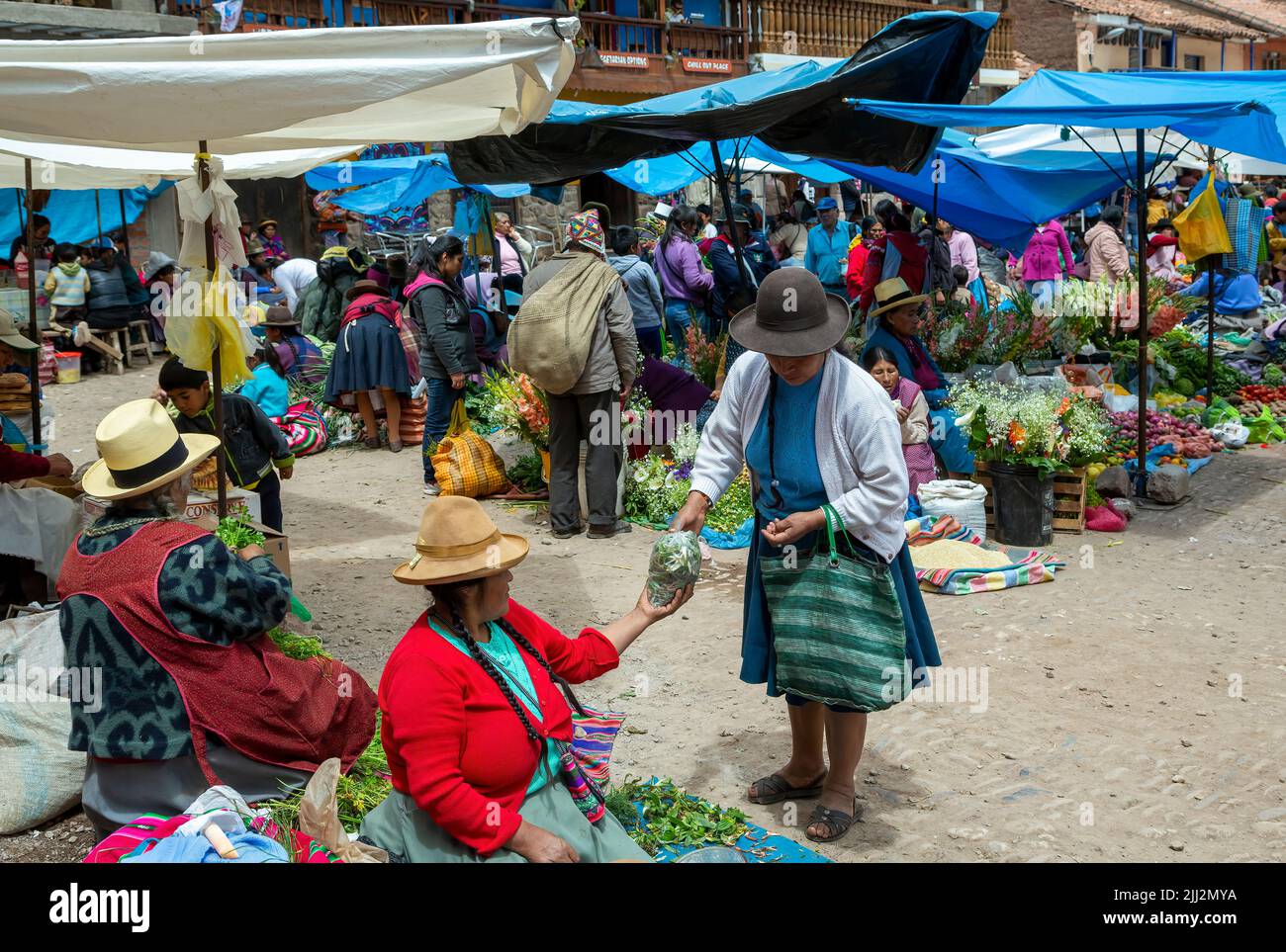 Quechua women and vendor stalls, Pisac Sunday Market, Cusco, Peru Stock Photo