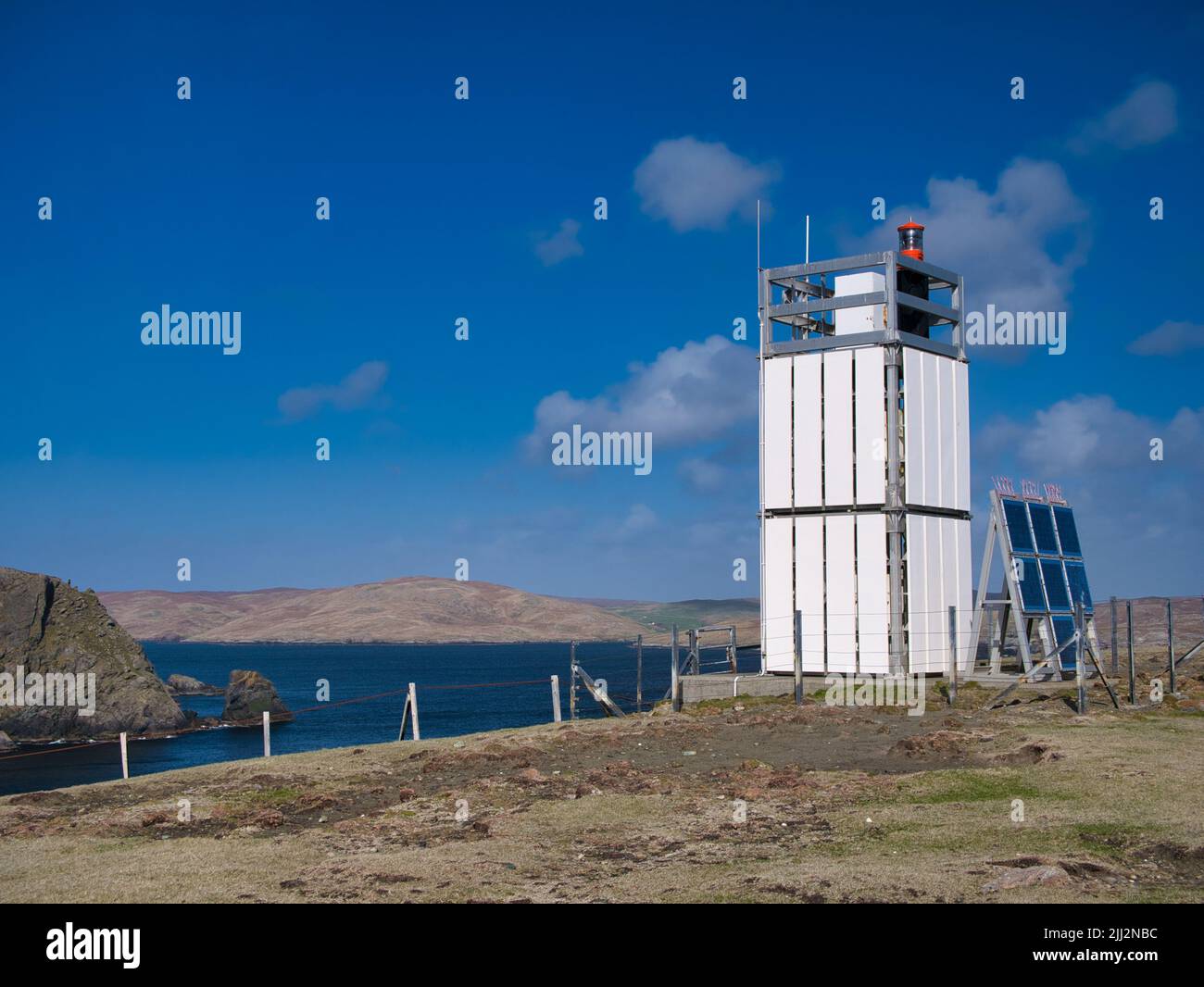 The automated lighthouse at Baa Taing on the Ness of Hillswick, Northmavine, Shetland, UK. Taken on a sunny day with blue sky. Stock Photo