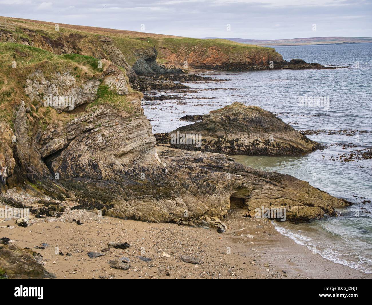 Geological folds and inclines in rock strata in coastal rocks near Ollaberry in Northmavine, Shetland, UK Stock Photo
