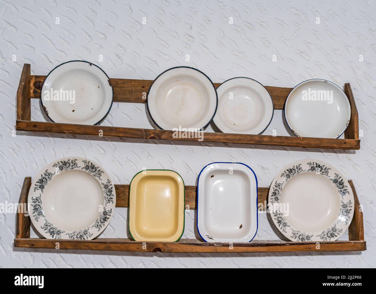 Old antique dishes over the white wall Stock Photo