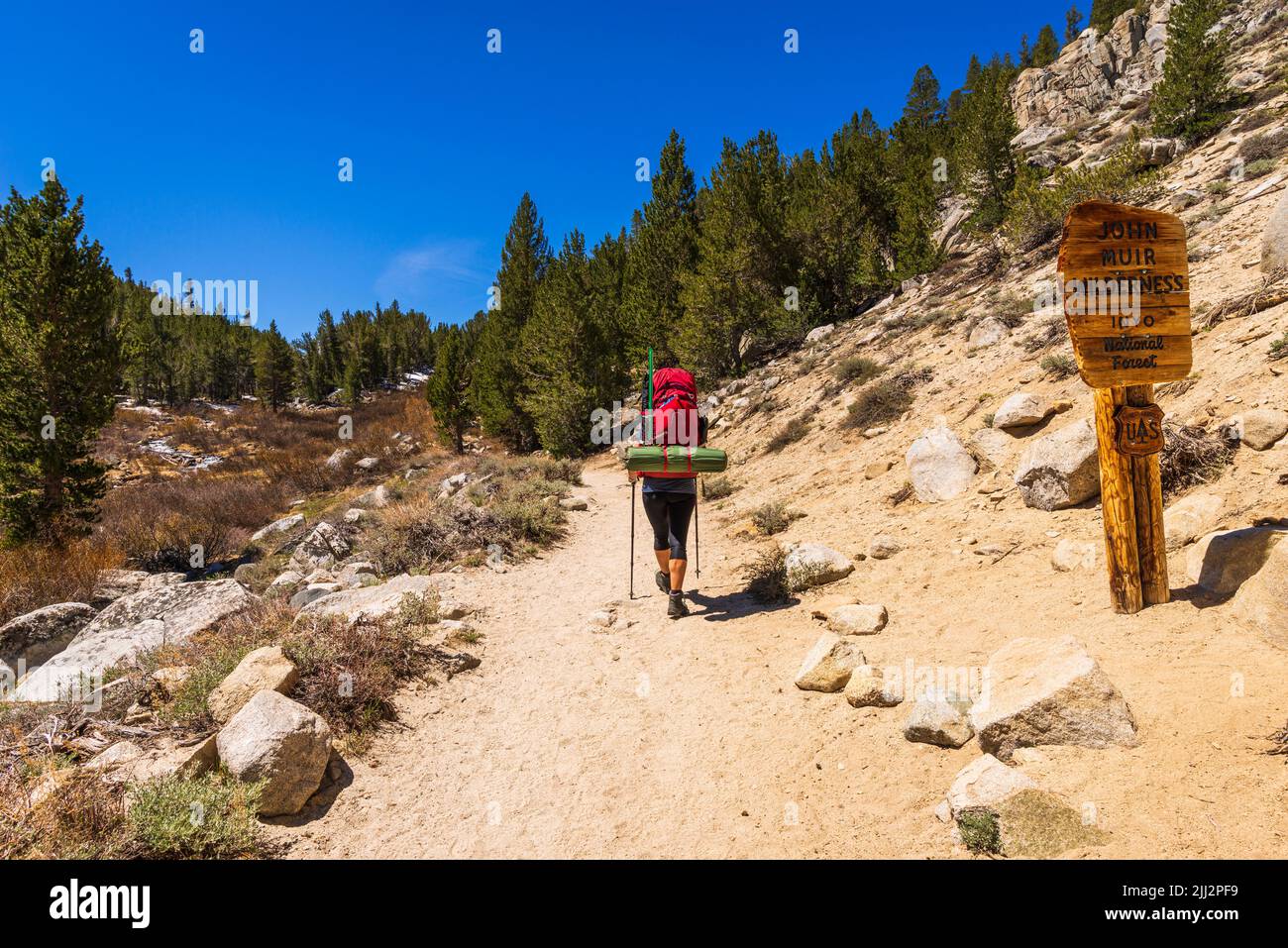 Woman backpacking in Little Lakes Valley (wilderness sign visible