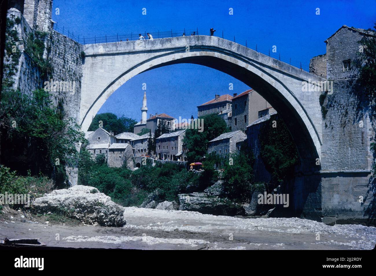 The original Old Bridge over the Neretva river in the city of Mostar, Bosnia and Herzegovina in May 1975 Stock Photo