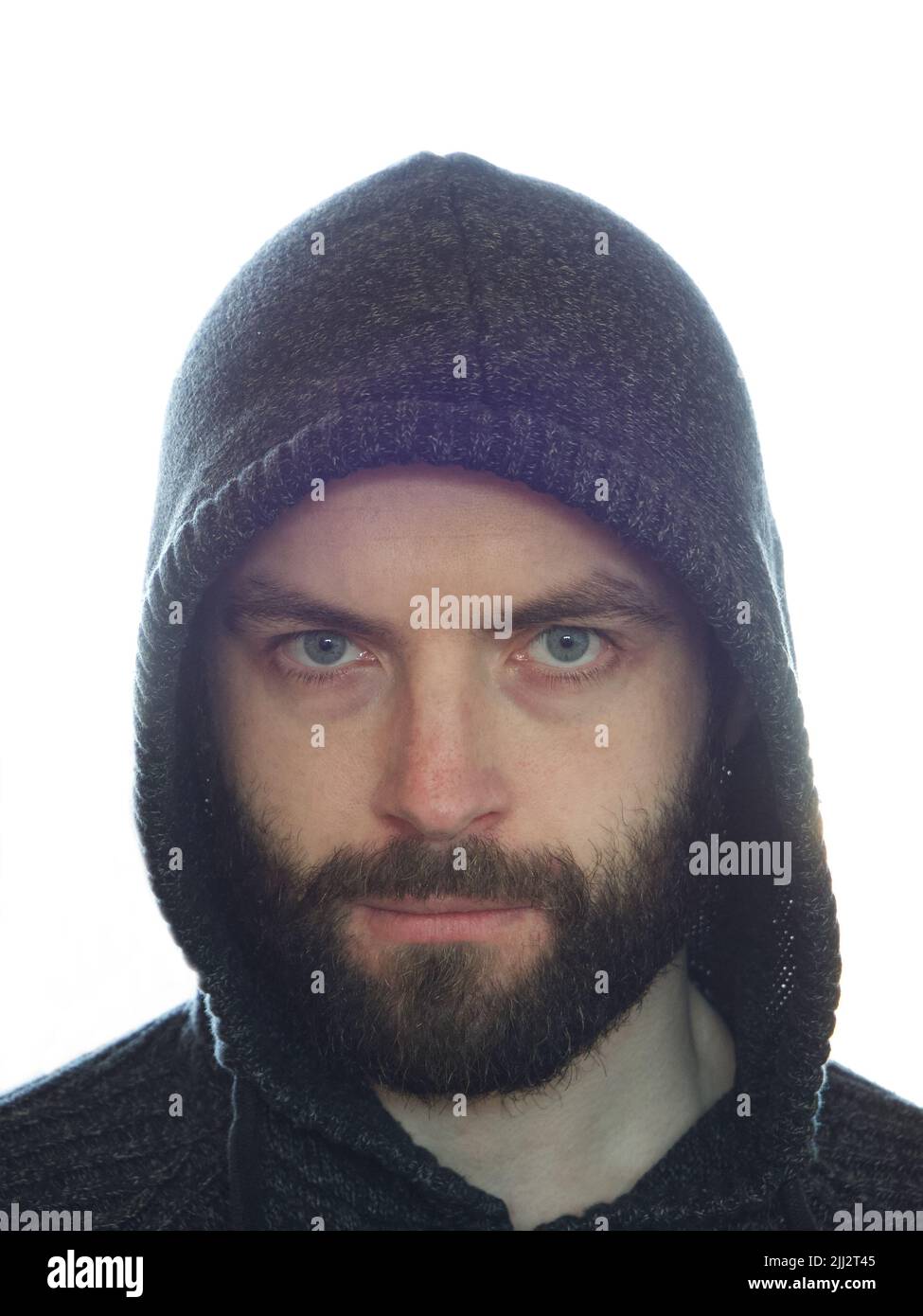 A bearded man in a hood, a close-up portrait. A close look. Stock Photo