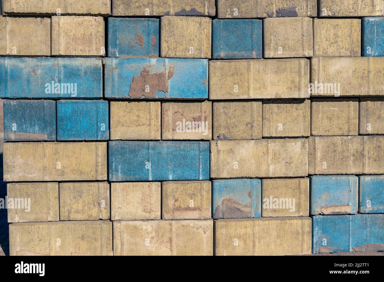 yellow-blue bricks with a rough texture. paving slabs Stock Photo