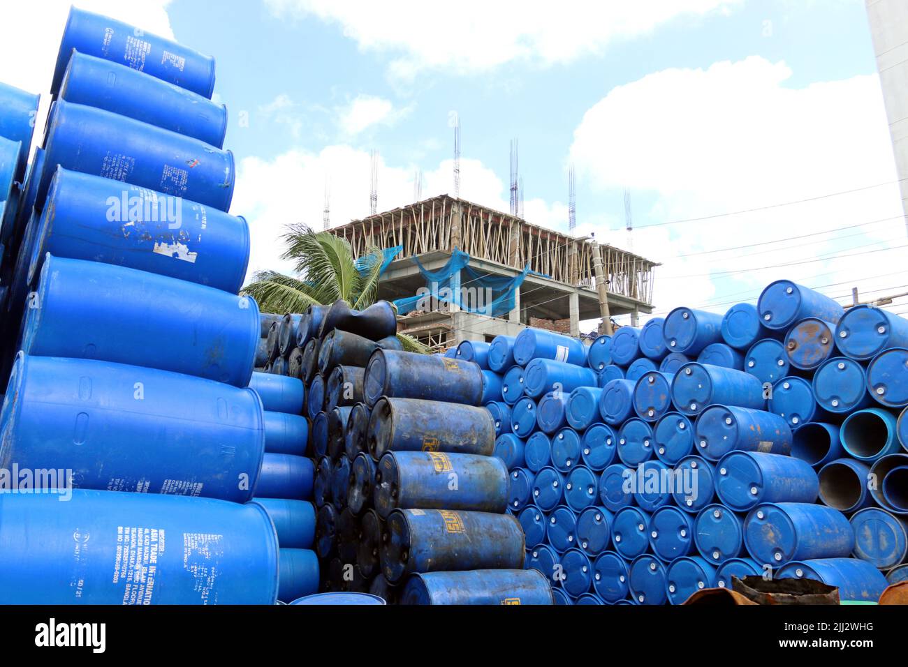 worker seen washing empty oil drums for recycling at a warehouse in Khulna outstrick Dhaka