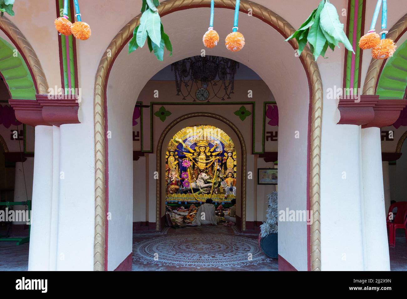Howrah, India -October 26th, 2020 : Hindu Purohit worshipping Goddess Durga inside old age decorated home. Durga Puja, biggest festival of Hinduism. Stock Photo