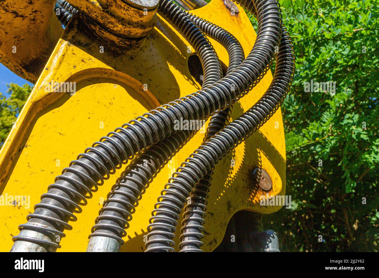 Hydraulic hoses on the bucket arm of a wheel loader for power transmission to the excavator bucket Stock Photo