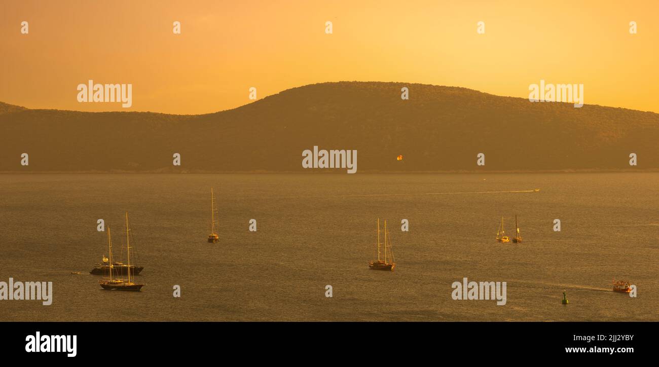 Boats and sunset on Bodrum shores. Aegean coast in summer. Turkey's famous tourist holiday destination Stock Photo