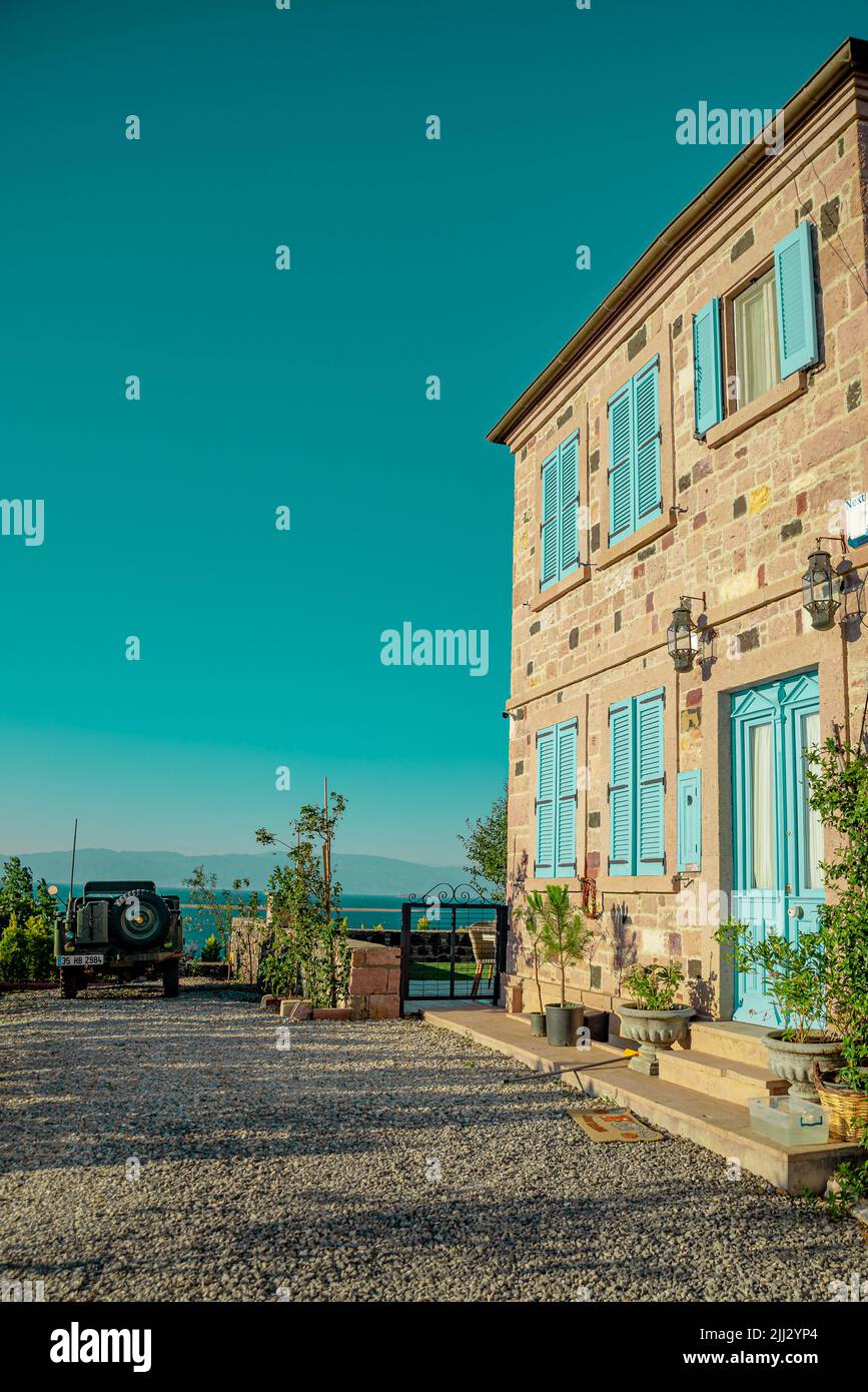 cottage stone house with blue windows Stock Photo - Alamy