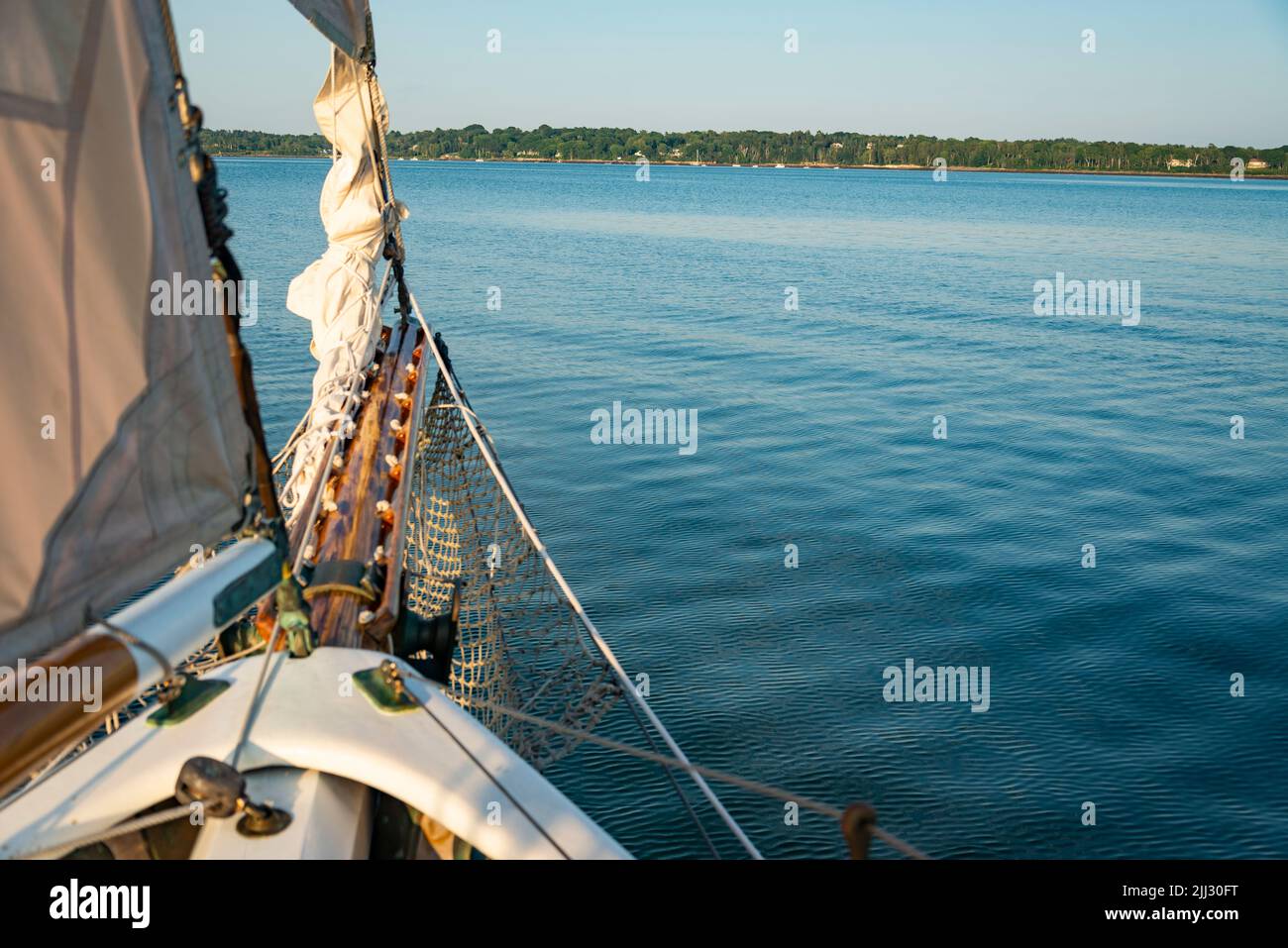 Sails folded and lashed to the bow on the Atalntic Ocean in Maine Stock Photo