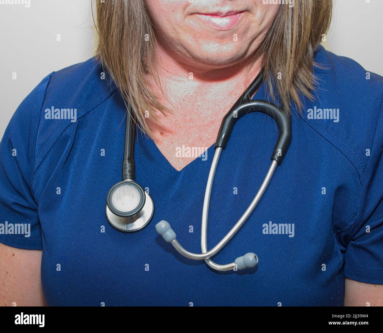 Partial body shot of a female Nurse wearing stethoscope around neck
