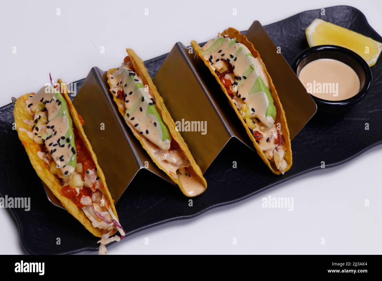 mexican food stuffed taco with seafood and chicken in a serving stand Stock Photo