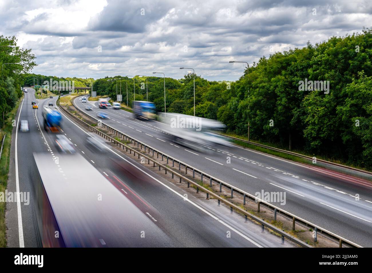 Cars driving on a motorway with motion blur from long exposure Stock Photo