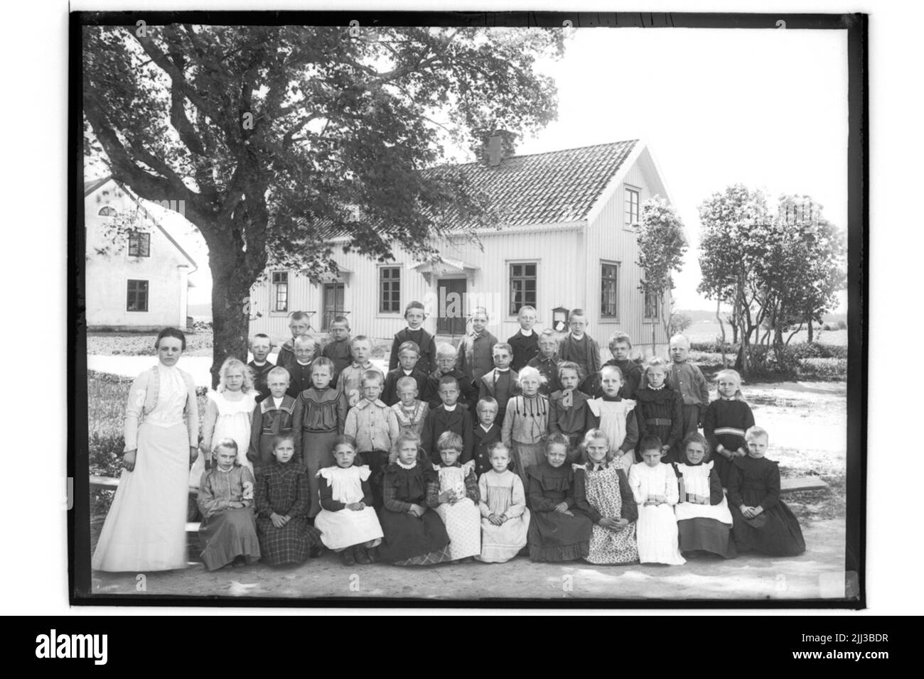 Rinkaby school, 38 school children, Miss and school building. Miss Beda Kruse. Stock Photo