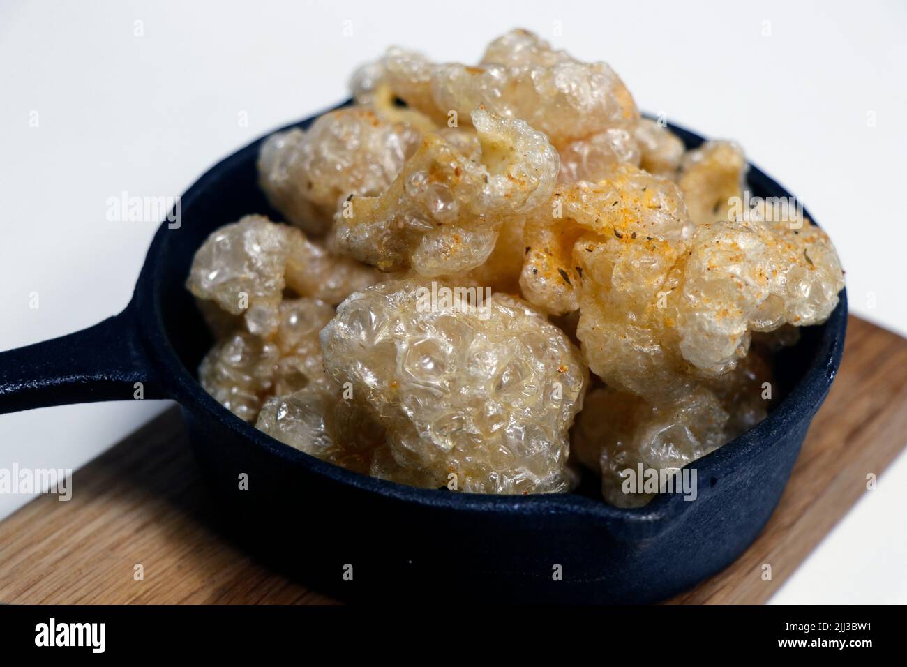 sun dried and deep fat fryer crispy pork skin known as chicharon in a serving dish, asian delicacy food Stock Photo
