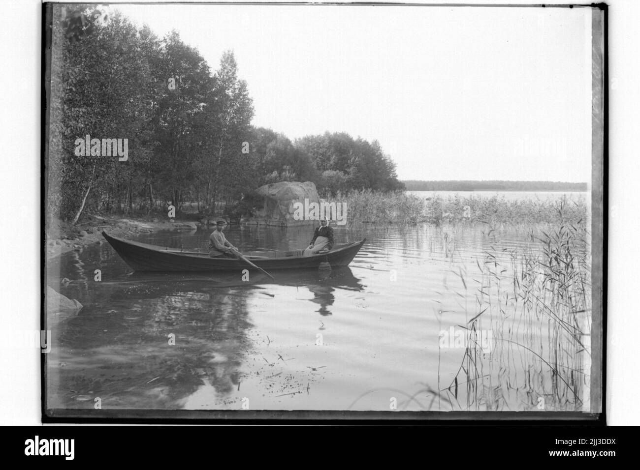 Two people in rowing boat Black and White Stock Photos & Images - Alamy