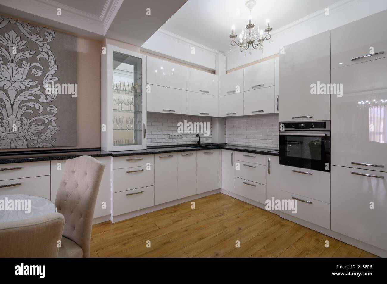 Luxury white modern kitchen with dining table Stock Photo - Alamy