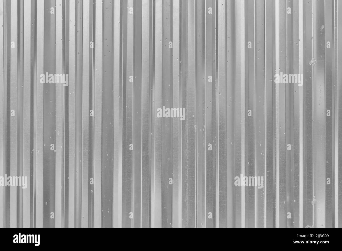 Corrugated Metal Silver Fence Steel Abstract Pattern Texture Grey Background. Stock Photo