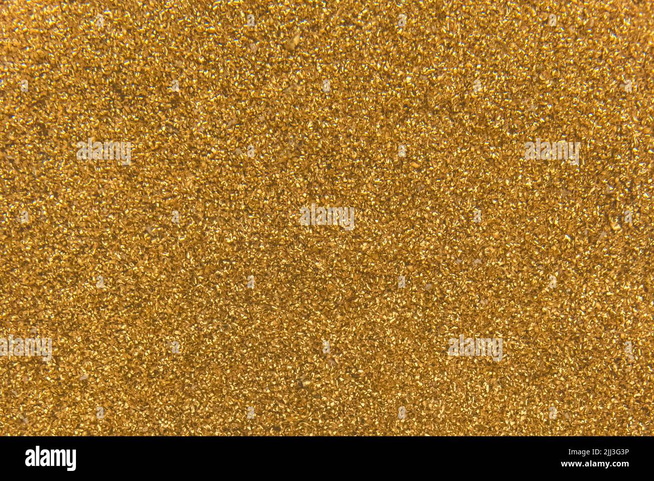 Golden yellow metal shavings waste steel recycling iron texture background. Stock Photo